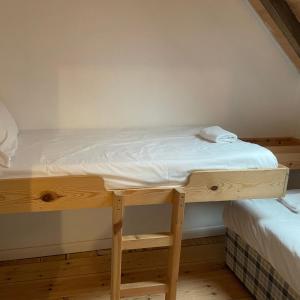 a bed in a room with a wooden desk at Loaf 3 at The Old Granary Converted Town Centre Barn in Beverley