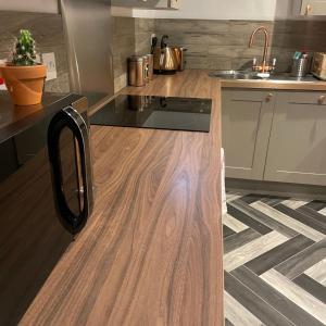 a kitchen with a wooden counter top and a sink at Loaf 3 at The Old Granary Converted Town Centre Barn in Beverley