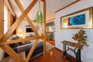 a living room with a staircase leading to a living room at Cantinho do Cantagalo in Angra do Heroísmo