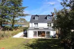 a white house with a view of the ocean at Cippinstone in Newport Pembrokeshire