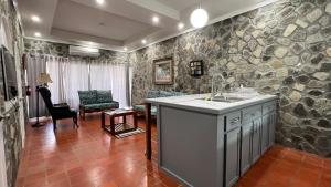 a kitchen with a sink and a stone wall at Stonetrail in Arnos Vale +55 photos