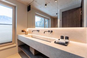 a bathroom with a large sink and a mirror at Villa Liesl by ALPS RESORTS in Haus im Ennstal