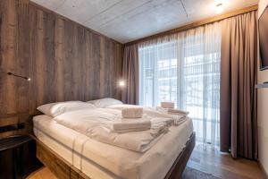 a large bed in a room with a large window at Villa Liesl by ALPS RESORTS in Haus im Ennstal