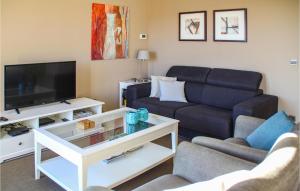 a living room with a couch and a tv at Nice Home In Caunes Minervois With Wifi in Caunes-Minervois
