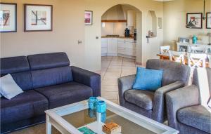 a living room with two couches and a table at Nice Home In Caunes Minervois With Wifi in Caunes-Minervois