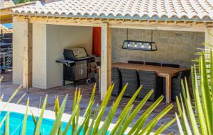 a backyard patio with a table and a grill at Nice Home In Caunes Minervois With Wifi in Caunes-Minervois