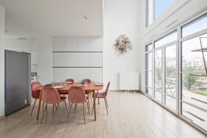 a dining room with a wooden table and chairs at Villa Riviera Near Disneyland Paris in Chessy