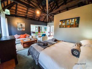 a bedroom with a large bed and a living room at Stay at Seodin in Wilderness