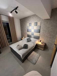 a bedroom with a king sized bed in a room at Premium Apartment Eleven in Zator