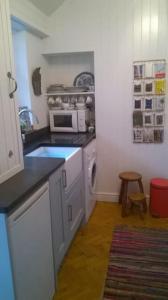 a small kitchen with a stove and a microwave at Cosy cottage with mountain views in Blaenau-Ffestiniog