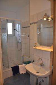 a bathroom with a shower and a sink and a shower at Seevilla Wietjes Whg 2 in Baltrum
