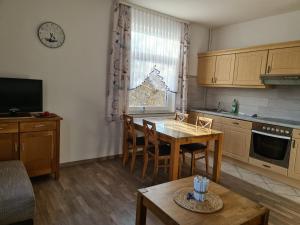 a kitchen with a table and a dining room at Seevilla Wietjes Whg 2 in Baltrum