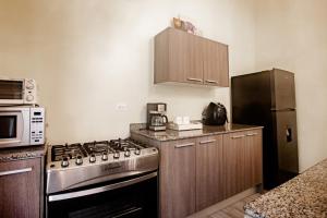 a kitchen with a stove and a refrigerator at Aparment Playa Venao - D in Pedasí Town