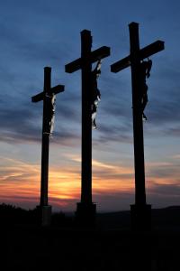 two crosses with people on them in front of a sunset at Pension Schwarze Berge 
