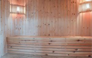 eine Holzsauna mit holzgetäfelter Wand in der Unterkunft Stunning Home In Ringkøbing With Sauna in Ringkøbing