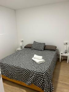 1 dormitorio con 1 cama en blanco y negro y 2 mesas en Apartamento independiente en Sant Cugat del Valles con piscina en Sant Cugat del Vallès