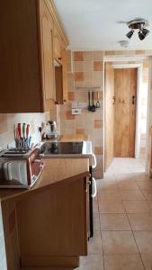 a kitchen with a sink and a counter top at Welcoming cottage in Chichester near City Centre in Chichester