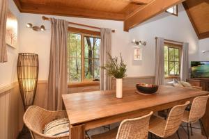 a dining room with a wooden table and chairs at The Lodge Blackheath in Blackheath