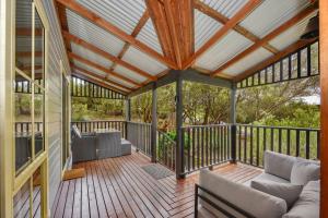 a screened in porch with a wooden roof at The Lodge Blackheath in Blackheath