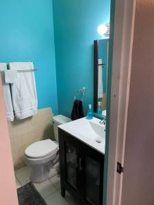 a bathroom with a white toilet and a sink at Authentic Puerto Rico - Near Beach & Old San Juan in Toa Baja