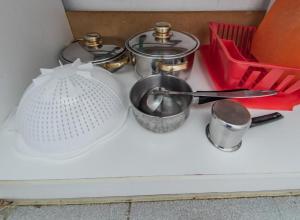 a counter top with a bunch of pots and pans at Ena-Lia Studios in Skala Marion