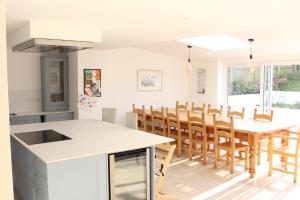 a kitchen and dining room with a table and chairs at Cippinstone in Newport Pembrokeshire
