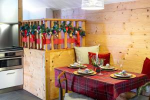 a table in a kitchen with christmas decorations at La Petite Grange in Villars-sur-Ollon