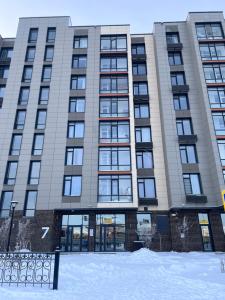 a building with snow in front of it at Квартира in Astana