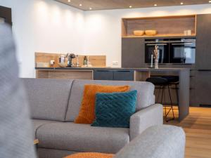 a living room with a couch and a kitchen at Penthouse Feldberg in Feldberg