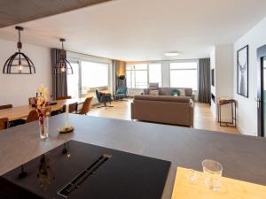 a living room with a table and a living room at Penthouse Feldberg in Feldberg