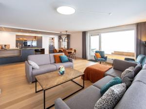 a living room with two couches and a table at Penthouse Feldberg in Feldberg
