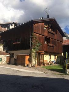 a large wooden building on the side of a street at Novità Booking a due passi dalla Ski Area in San Vito di Cadore