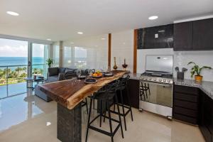 a kitchen with a large island with a counter top at Amara, depa con vista al mar in Cancún