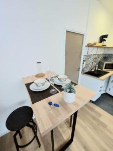 a kitchen with a table with two dishes on it at Studio confort #2, proche Gare et commodités in Maubeuge