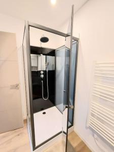 a shower with a glass enclosure in a bathroom at Studio confort #2, proche Gare et commodités in Maubeuge