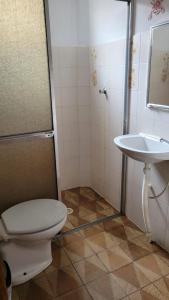 a bathroom with a toilet and a sink at Casa da Voh in Ilha Comprida