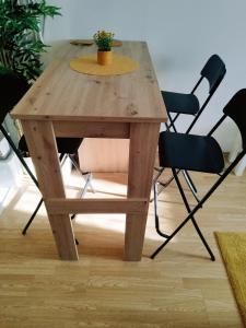 a wooden table and chairs with a plant on it at Studio Apartment TIM in Zagreb
