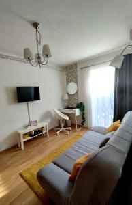 a living room with a couch and a tv at Studio Apartment TIM in Zagreb
