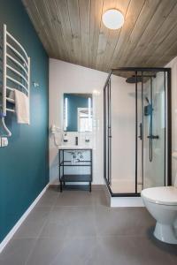 a bathroom with a toilet and a glass shower at УЛІС in Dudky
