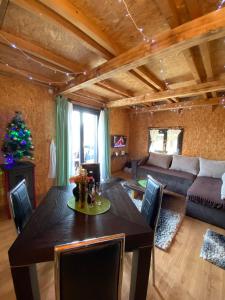 a living room with a table and a couch at Vila Luka i Ana - Apartman Ana in Zaovine