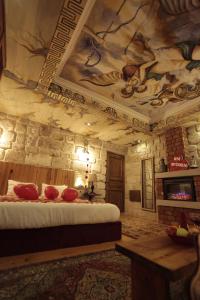 a room with a bed and a painting on the ceiling at Corner in Cappadocia in Nevsehir