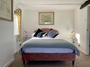 a bedroom with a large bed with black and white pillows at Taylor Way in Aberystwyth