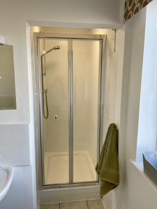 a shower stall in a bathroom with a sink at Taylor Way in Aberystwyth