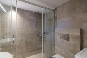 a bathroom with a shower with a glass door at Nice And Spacious Apartment In Paros in Naousa +26 photos
