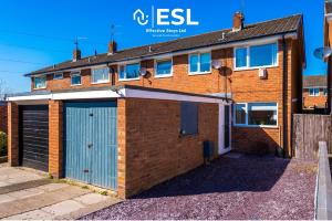 an image of a brick house with a garage at 3 Bedroom House with Garden and Driveway Parking - Less than 10 Mins from Chester City Centre in Chester