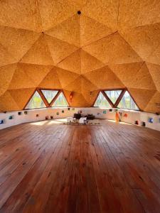 a large room with a wooden floor and windows at DomosdeMar in Ocean Park