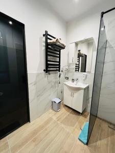 a bathroom with a sink and a mirror at Colombia Apartments&Rooms in Durrës