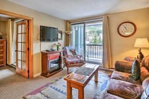 a living room with a couch and a tv at Copper Mountain Ski-inandSki-Out Condo with Balcony! in Copper Mountain