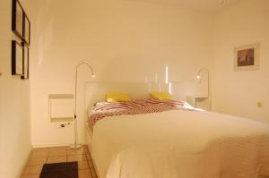 a bedroom with a large white bed with yellow pillows at Bon Air in Thalfang