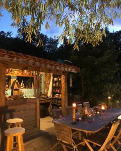 uma mesa com velas num deque com bar em Villa Bonheur Vallespir em Céret